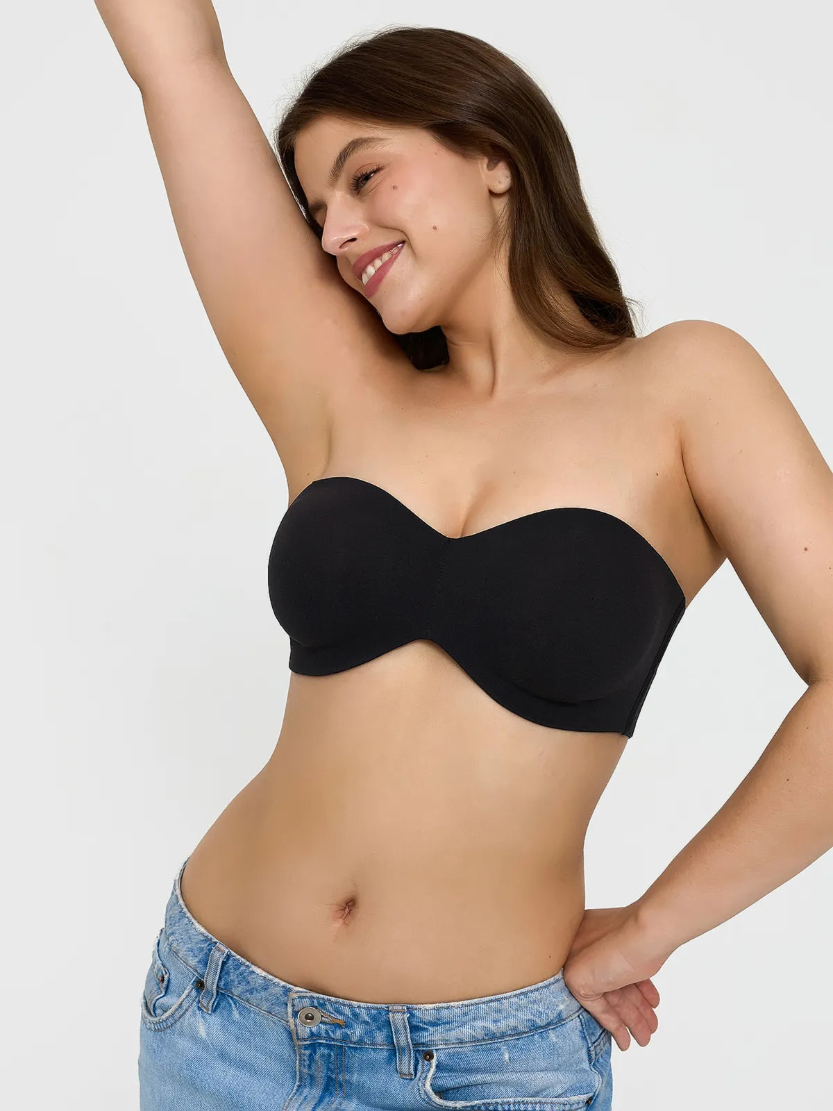 Popilush? black seamless push-up bra, ideal for shapewear dresses. Confident model in denim.